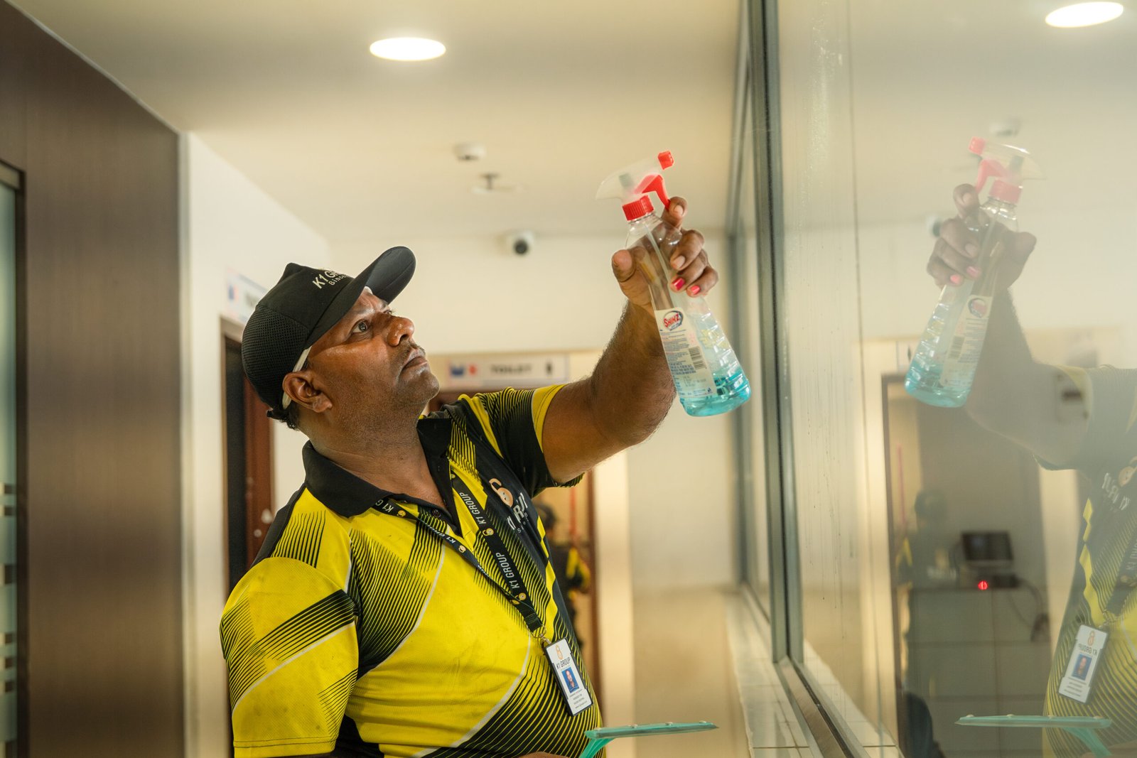 K1 Care associate cleaning an office space